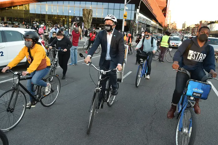 Andrew Yang attends a bike ride protest in the wake of the police killing Daunte Wright.